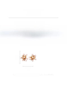 Dettaglio degli orecchini a fiore con petali rosa, base in rame e centro in zircone