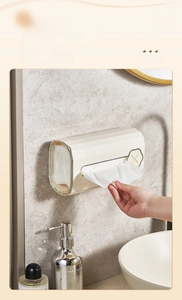 Macro view of cream wall-mounted tissue box with U-shaped opening for easy extraction
