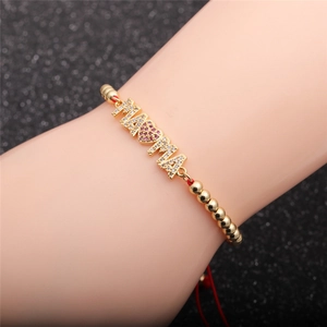 Gold-plated MAMA heart bracelet with zircon stones and adjustable red cord on wrist