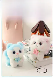 Detail of plush angel cats in blue and pink colors with soft texture and floral accents