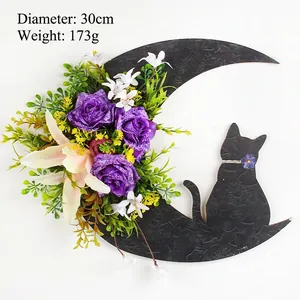 Detail of Halloween crescent moon cat wreath with purple roses and 30cm diameter size