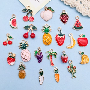Colorful fruit and plant alloy pendants for DIY jewelry making on light blue background
