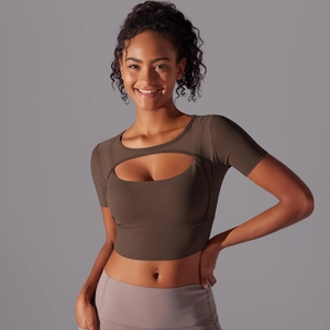 Detail of mesh paneled olive sports top with cutout front for yoga and fitness training
