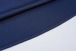 Detailed view of precision stitching and smooth dark blue fabric texture on the dress