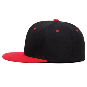 Détail de la casquette snapback bicolore avec couronne noire et visière plate rouge