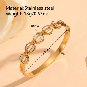 Bracelet jonc en acier inoxydable doré avec nacre blanche et motifs floraux diamantés