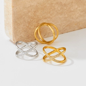 Crossed X-shape stainless steel rings with micro-pave crystals in gold and silver