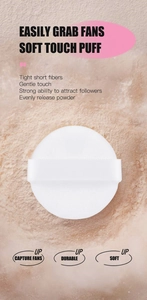 Macro shot of a soft white round makeup puff with ribbon handle for setting powder