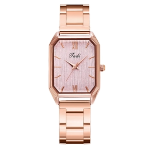 Detailed close-up of rose gold rectangular watch with pink sunray dial and link bracelet