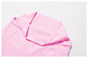 Detail of high-waisted pink yoga shorts showing wide waistband and functional side pockets