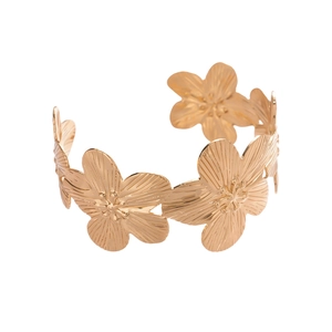 Golden metal cuff bracelet featuring textured floral patterns and open-ended design