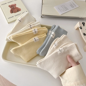 Cozy cream-colored cotton ribbed crew socks for women in beige, yellow, and blue colors