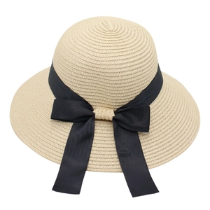 Elegant wide-brim straw sun hat with a large black ribbon bow for women's beach vacation