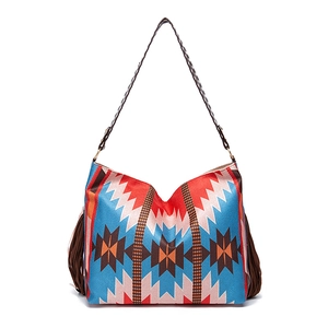 Detail of woven boho tote bag with geometric ethnic patterns and dark brown side tassels