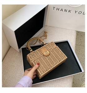 Detailansicht der gewebten Box-Tasche mit goldenem Drehverschluss und Kettenriemen