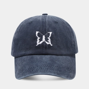 Faded washed navy cotton baseball cap featuring detailed white butterfly embroidery on front