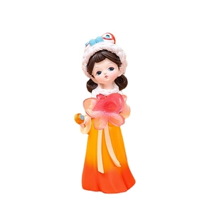 Traditional Chinese girl resin figurine with lion dance hat and yellow hanSurprisingly dress