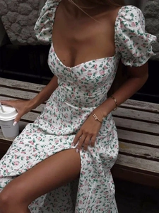 Close-up of floral off-shoulder maxi dress featuring puff sleeves and a high side slit