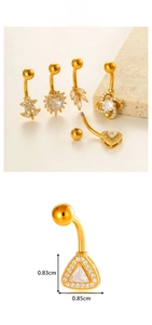 Detailed view of 5-piece gold navel rings set with heart and flower zirconia charms