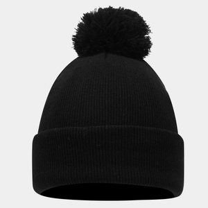 Detailed close-up of the ribbed knit texture and soft pom-pom on this black winter beanie