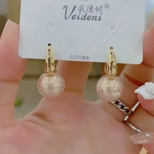 Detail view of long tassel pearl earrings with pink beads and S925 silver needles