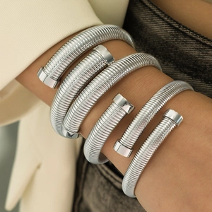 Minimalist silver Tubogas wrap bracelet with vertical texture and adjustable open design