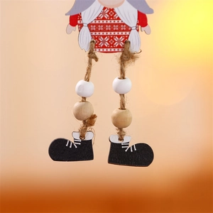 Detailed macro view of Christmas gnome hanging legs with wooden beads and black boots