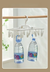 Detail view of durable laundry rack showing heavy weight capacity with dual water bottles