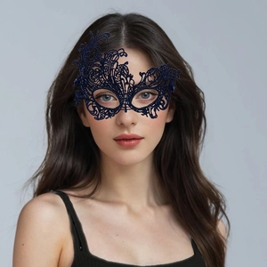 Detailed view of dark blue lace masquerade mask with intricate cutout patterns