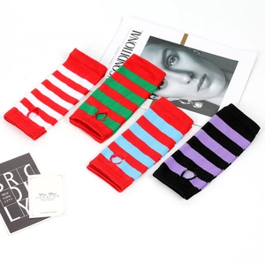Flat lay of colorful striped knitted fingerless arm sleeves in four vibrant colorways