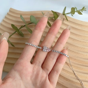 Detail of S925 silver tennis bracelet featuring a pink heart stone and clear zircon