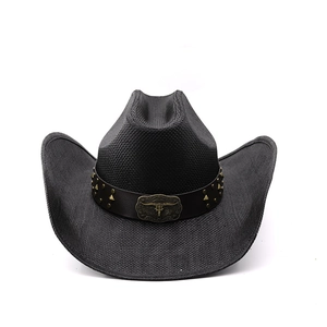 Close-up of black straw cowboy hat with brown leather band and bull skull emblem
