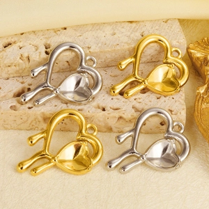 Detailed macro view of gold and silver heart-shaped stainless steel jewelry pendants