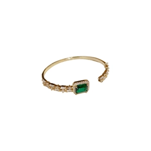 18K gold plated open bracelet featuring emerald green zircon and rectangular baguette crystals