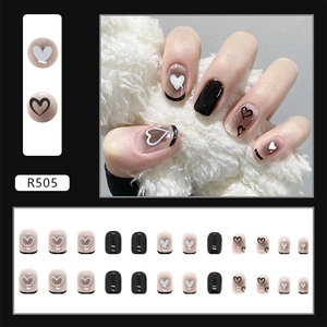 Detail view of black heart press-on nails set with 24 pieces in different sizes