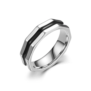 Detail view of faceted titanium steel ring with sleek black enamel inlay finish