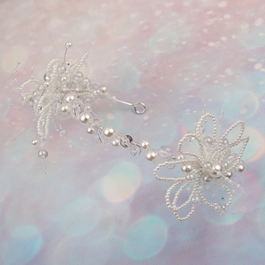 Detailed view of bridal headband with white beads and crystal flowers on soft background