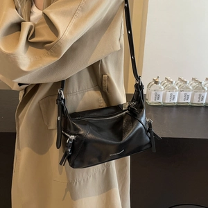 Black leather large tote bag with metallic zippers and minimalist chic motor style