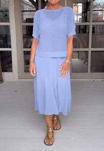 Dettaglio del set in maglia azzurra traforata con top e gonna abbinata in esterno