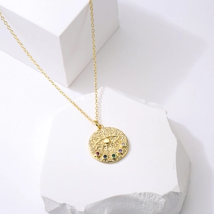 18K gold-plated copper evil eye pendant necklace with colorful zircons on stone pedestal