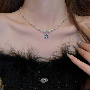 Macro view of water-drop pearl necklace with zircons worn on neck for luxury style
