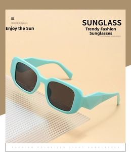 Close-up of mint green square sunglasses featuring wide temples and polarized lenses