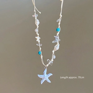 Detail of 70cm wax cord necklace with blue starfish, sea shells and pearl beads