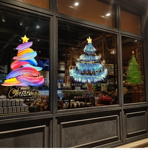 Close-up of festive Christmas tree window stickers with Merry Christmas text on shop glass