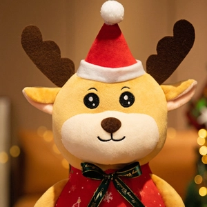 Cute Christmas reindeer plush toy with red hat and green ribbon in festive setting
