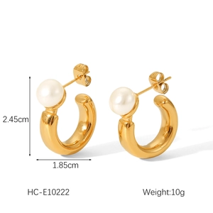Detail showing dimensions of C-shaped gold earrings with white pearl and metal texture