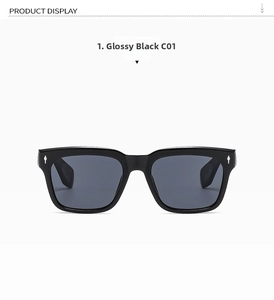 Detail view of black square sunglasses featuring silver arrow rivets and grey lenses