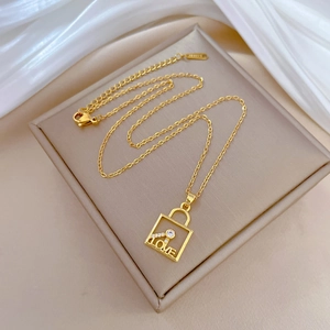 Elegant gold titanium steel necklace with a glittering crystal-set LOVE lock pendant