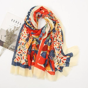 Artistic abstract floral print cotton linen scarf with frayed edges on a clean background
