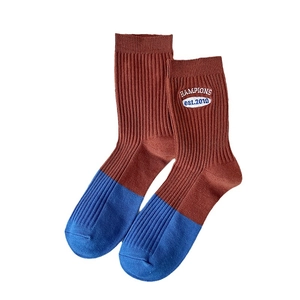 Women's cotton crew socks with brown and blue color blocking and embroidered patch